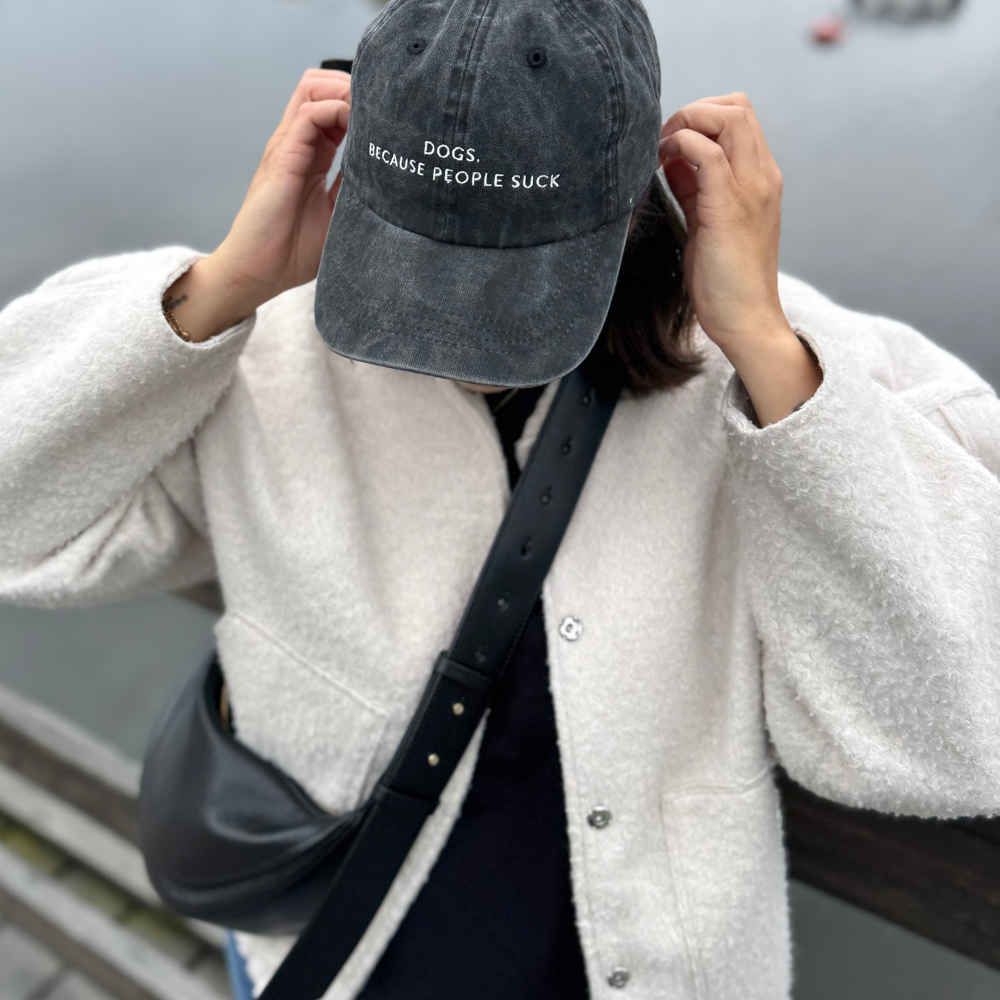 black-denim-cap-dogs-because-people-suck-woman-wearing.jpg